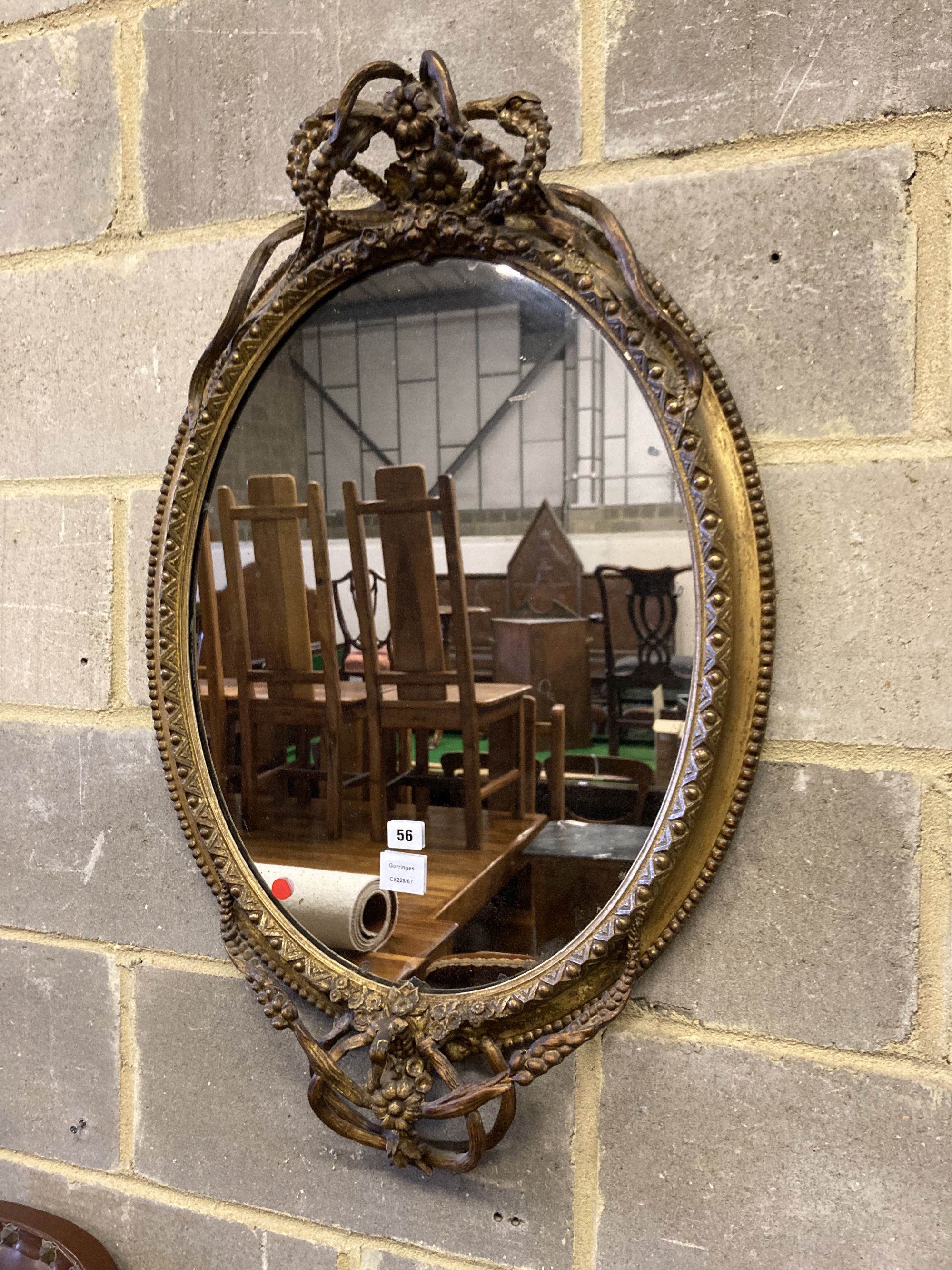 A Victorian giltwood and composition oval wall mirror, width 56cm, height 88cm